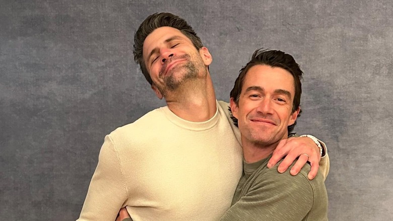 Robert Buckley and James Lafferty hug in 2024