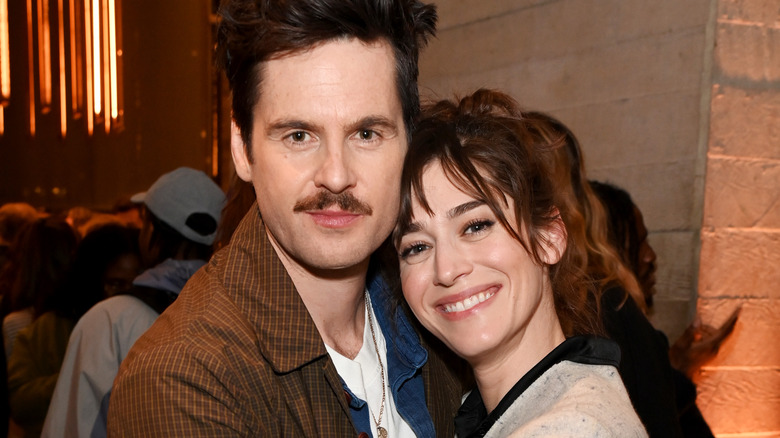 Tom Riley and Lizzy Caplan smiling