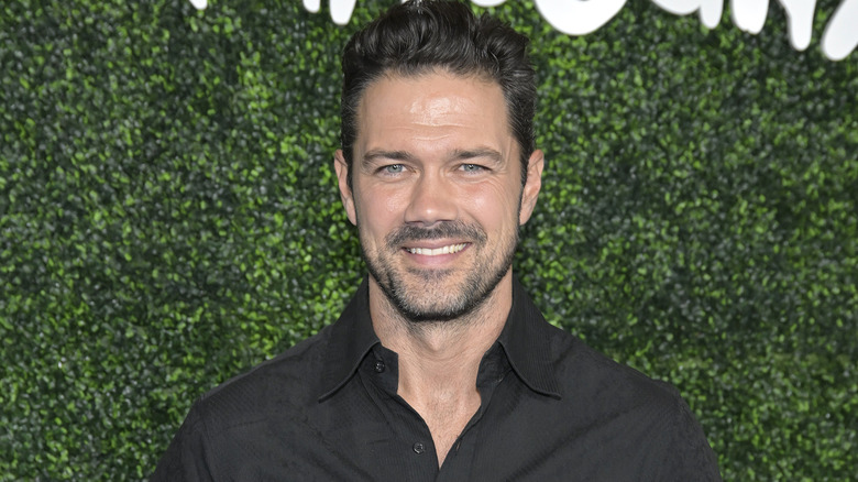 Ryan Paevey smiling at an event