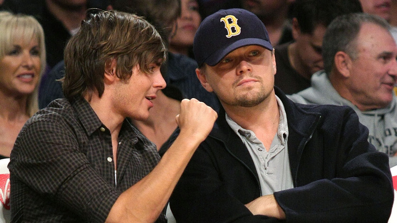 Zac Efron talking to Leonardo DiCaprio