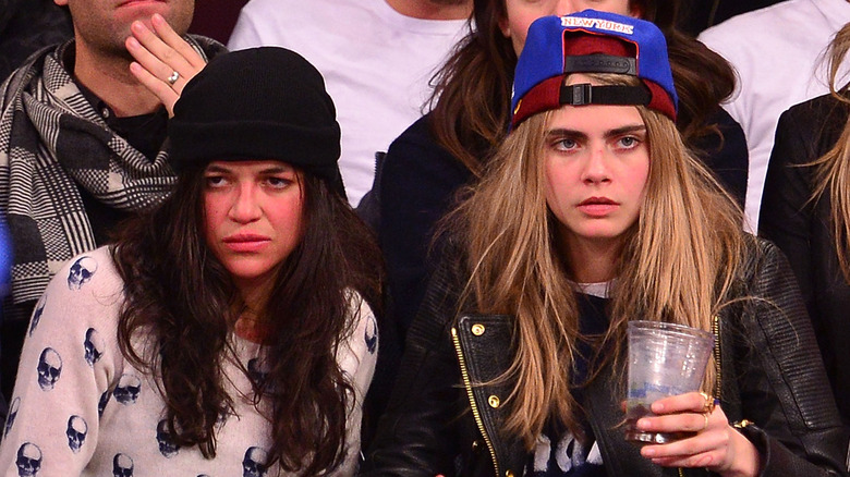 Michelle Rodriquez sitting with Cara Delevingne 