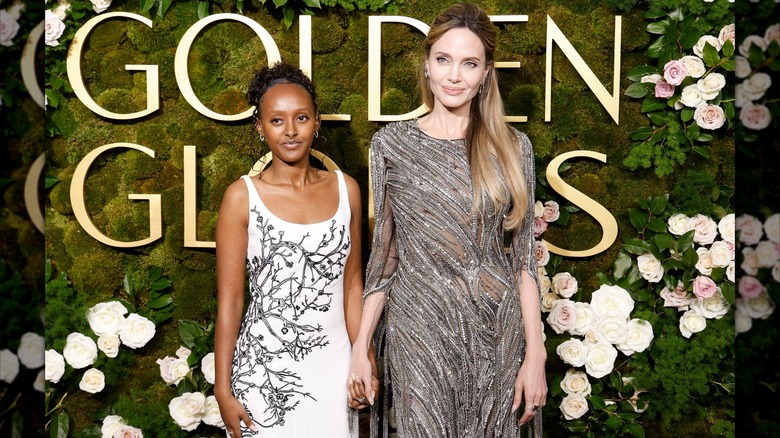 Zahara Jolie holding hands with Angelina Jolie at the 2025 Golden Globes