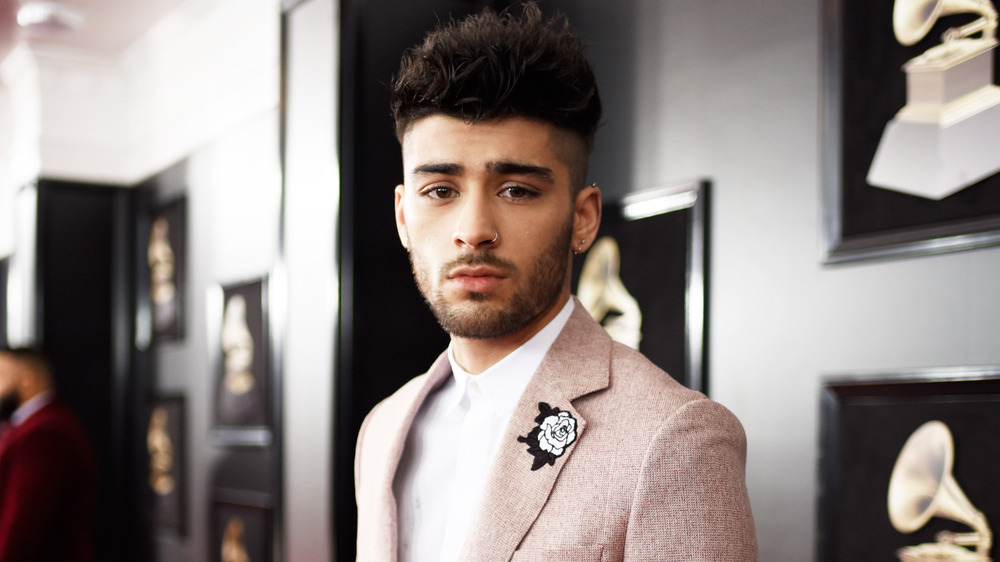 Zayn Malik walks the red carpet at the Grammy Awards