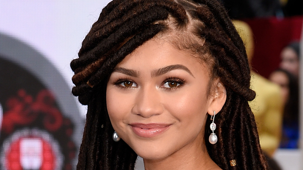 Zendaya smiling with locs