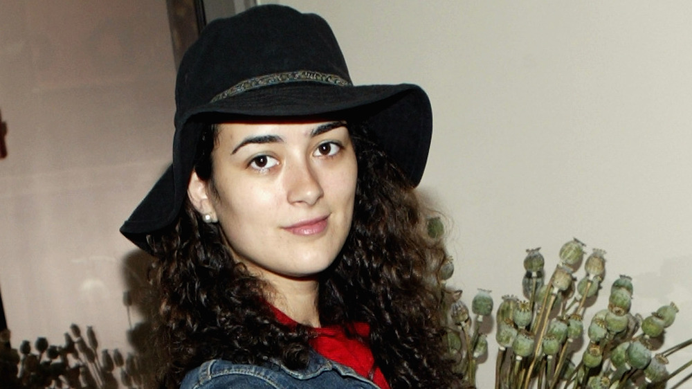 Cote de Pablo wearing a black hat in 2004