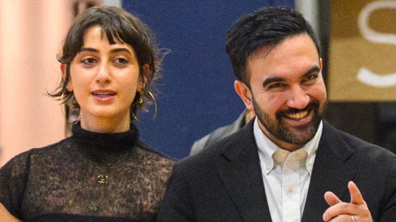 Zohran Mamdani and Rama Duwaji walk toward their voting booth in November 2025