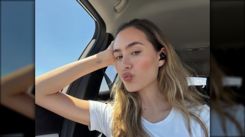 Alexandra Lamas pouting for a car selfie.