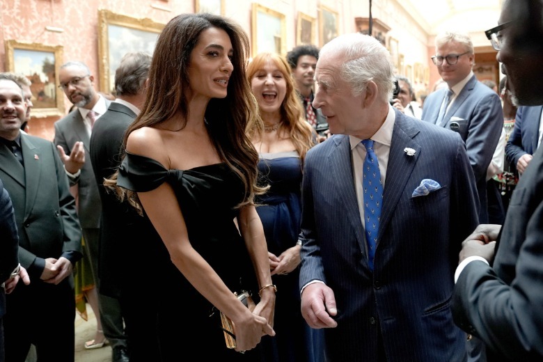 Amal Clooney with King Charles II in a crowded room