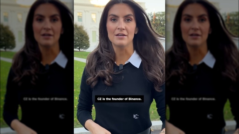 Kaitlyn Collins wearing a collared shirt and dark sweater with her initial monogrammed on the front