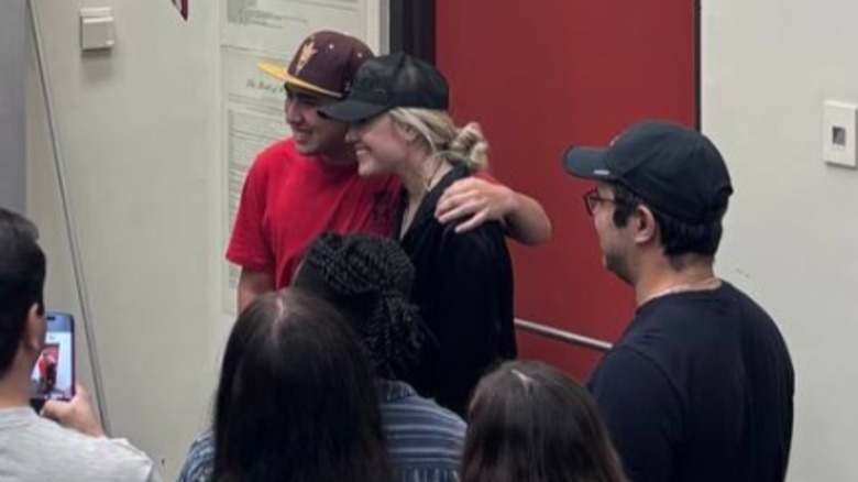 Erika Kirk posing with a student at Arizona State University.