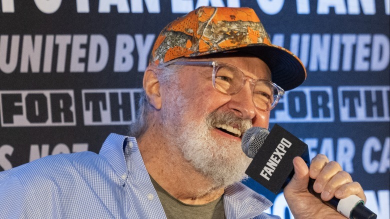Randy Quaid speaks into a mic