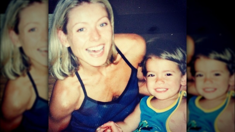 Kelly Ripa holding Michael Consuelos