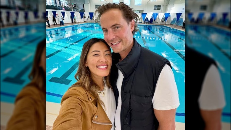 Angela and Erik von Detten posing together at a pool.