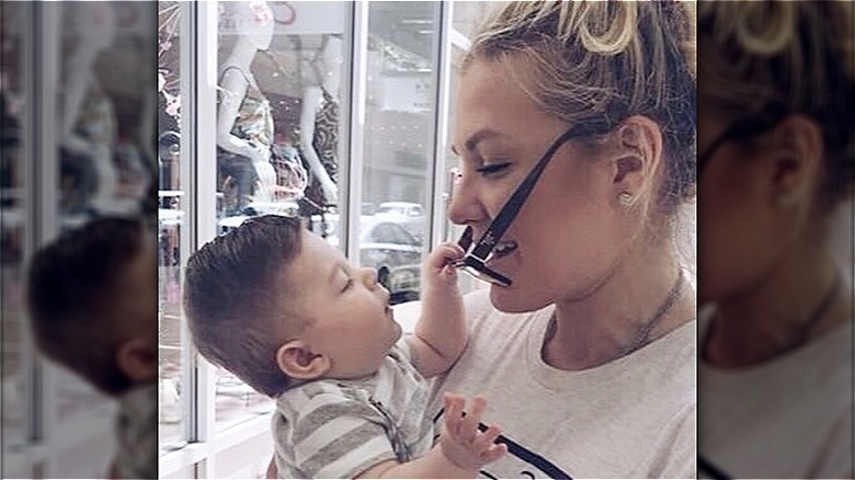 Erika Kirk holding her friend's baby