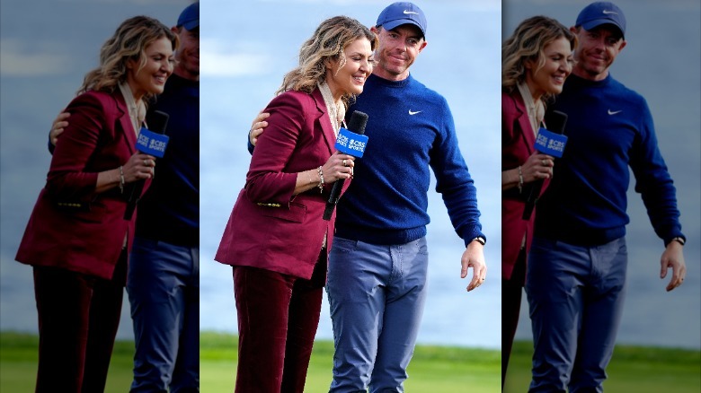 Rory McIlroy placing an arm around reporter Amanda Balionis as she laughs.