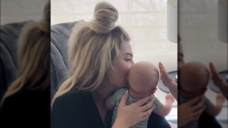 Erika Kirk kissing her newborn son.