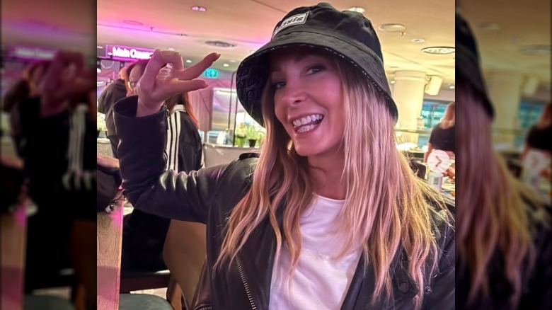 Joanne Froggatt posing playfully at an Oasis concert.