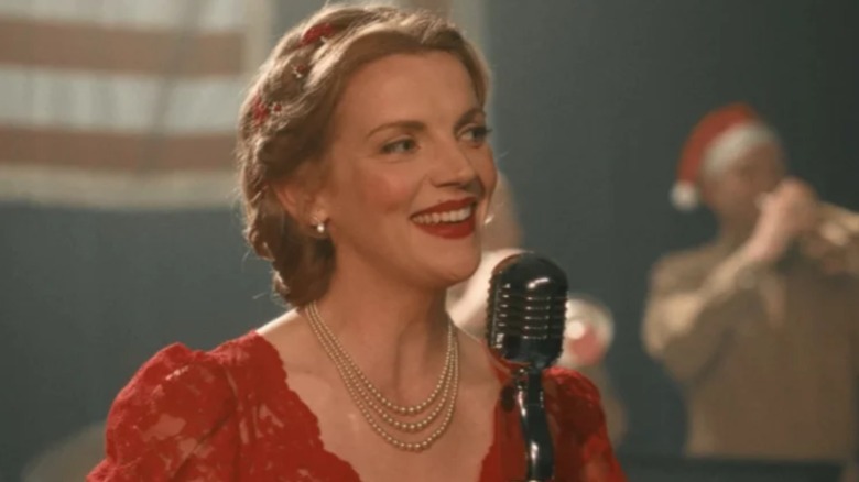 Kara Killmer singing on stage in a red dress in the movie