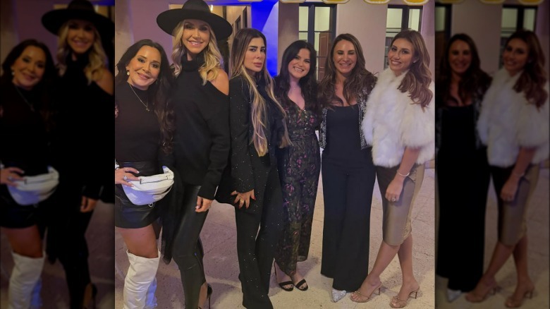 Alina Habba wearing gold dress and fur coat while posing with partygoers