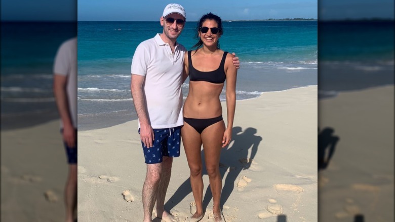 Stephen and Katie Miller pose together on the beach during their honeymoon.
