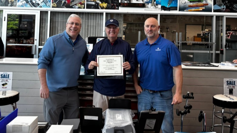 Linsey Graham presenting Travers Tool Company with a certificate.