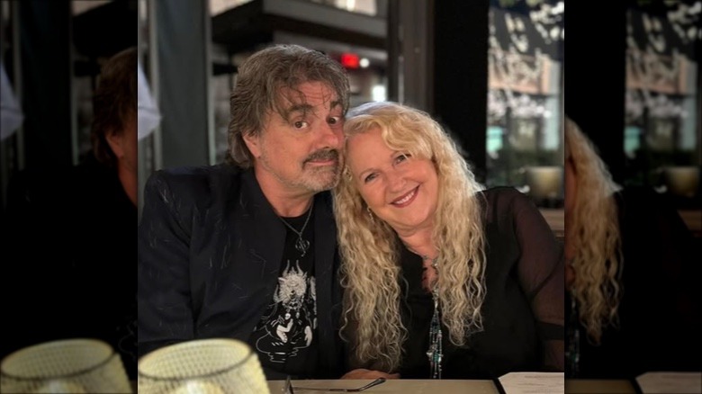 Sherry Hursey and partner posing at dinner