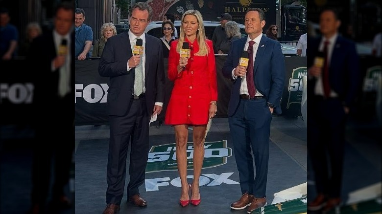 Ainsley Earhardt wearing red dress and reporting on the Indy 500