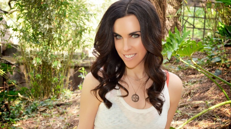 Caprice Crane poses in the woods in 2020