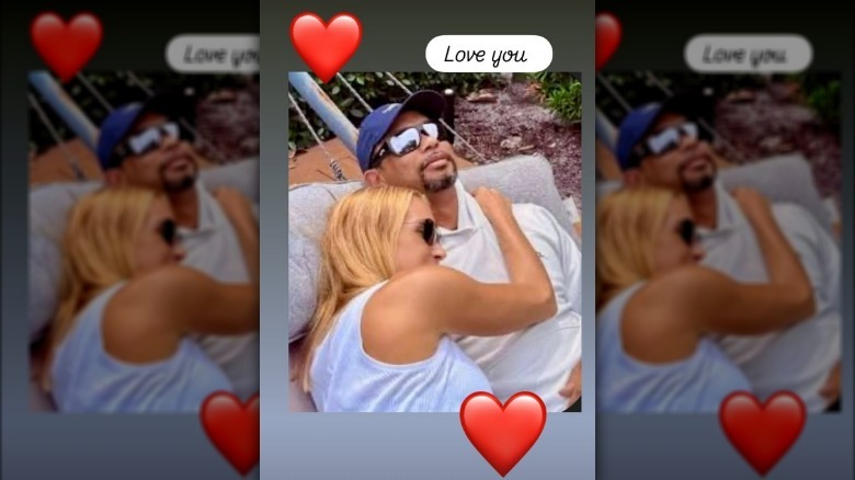 Vanessa Trump lying beside Tiger Woods and embracing him.