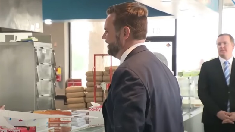 JD Vance pictured from behind in a donut shop.