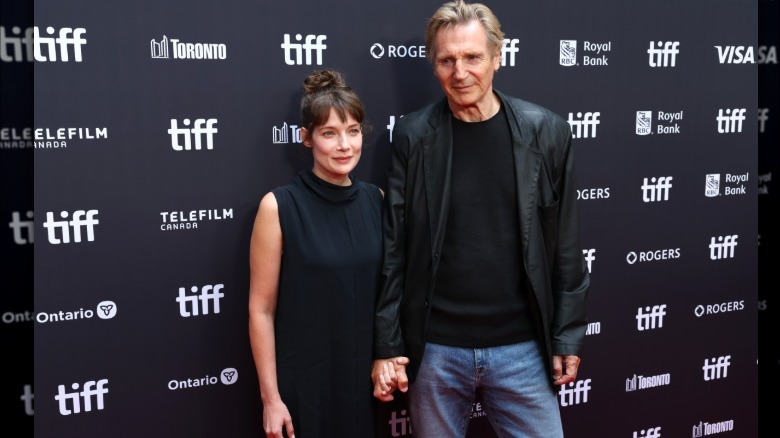 Liam Neeson holding hands with stella stockard