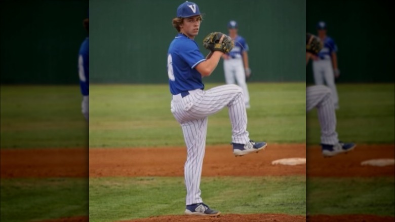 Duke Gaines pitching in a blue baseball uniform