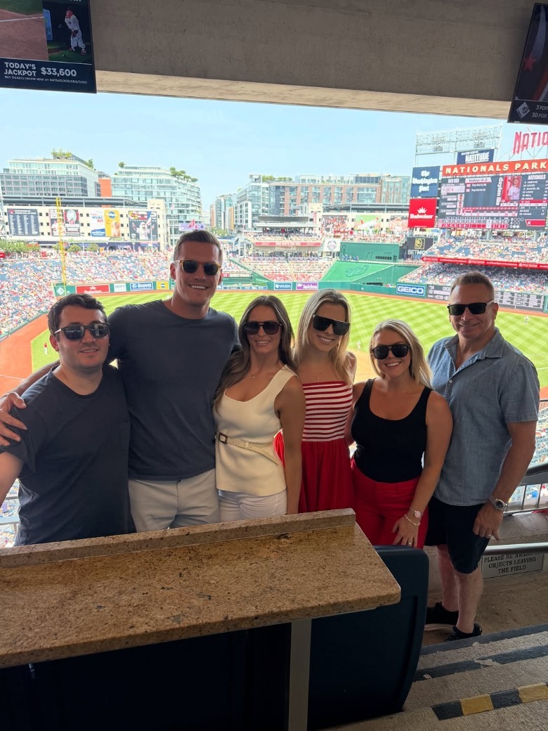 A group photo at a baseball game including Margo Martin